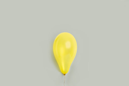 A yellow balloon on a gray backgroundの写真素材