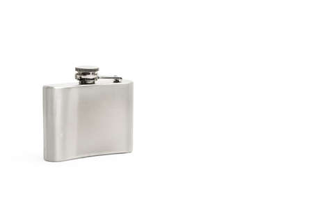 Metal hip flask on a white background with copy spaceの写真素材