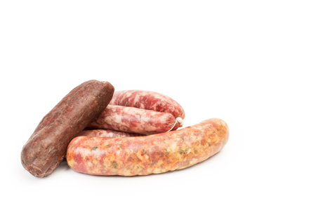 Sausages and black pudding on a white backgroundの写真素材