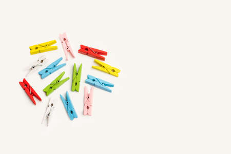 Colored clothespins on gray background with copy space