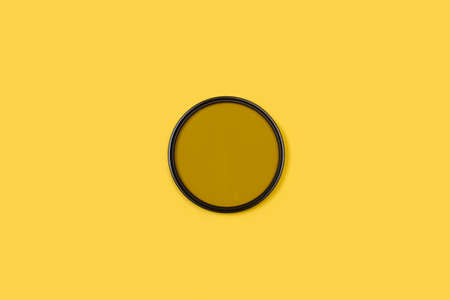 A polarizing filter on a yellow background with copy spaceの写真素材