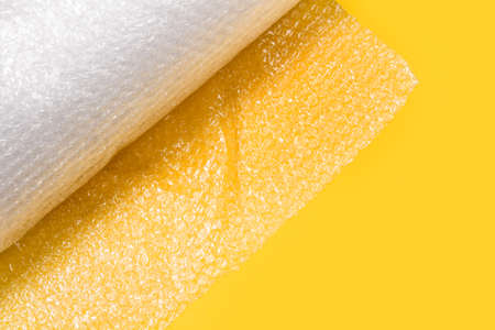 A roll of air cushioning bubble wrap on a yellow background