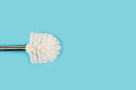 A toilet brush on a light blue background with copy spaceの写真素材