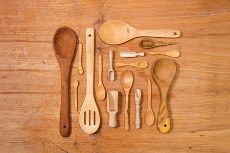 Wooden spoons on a wooden table in a top view