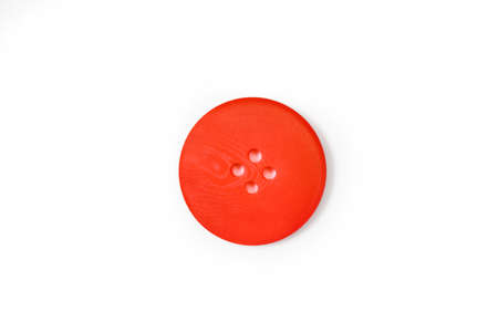 A red button isolated on a white background in a close up viewの写真素材
