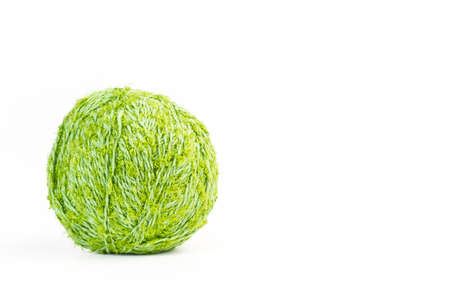 Green wool ball on a white background with copy space