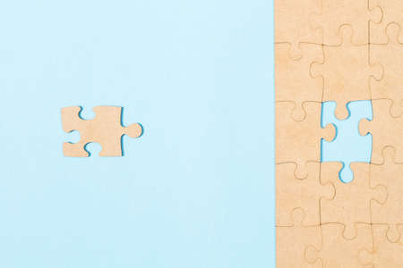 The correct missing puzzle piece on a light blue background in a top view