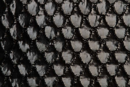 A texture of a black satin cloth in a close up view