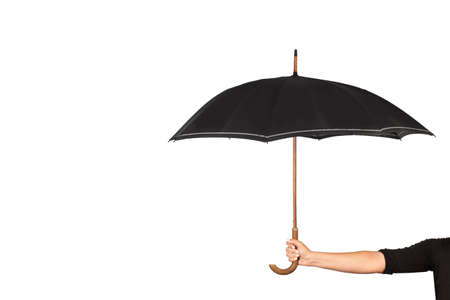 Woman hand holding a black umbrella on a white background with copy spaceの写真素材