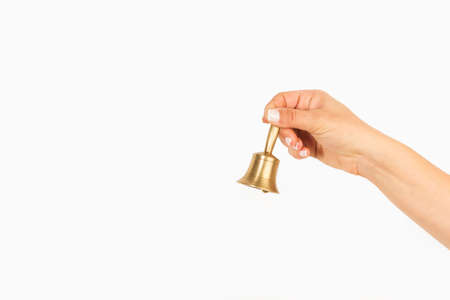 Woman hand holding a bronze bella on a white background with copy spaceの写真素材