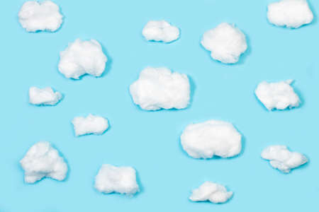 Clouds shaped cotton on a blue background with copy space