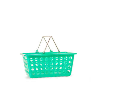 A green plastic supermarket basket on a white background with copy space