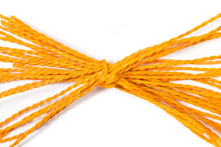 Orange plastic tied ropes on a white backgroundの写真素材