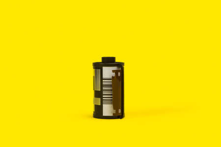 A film roll on a yellow background with copy spaceの写真素材