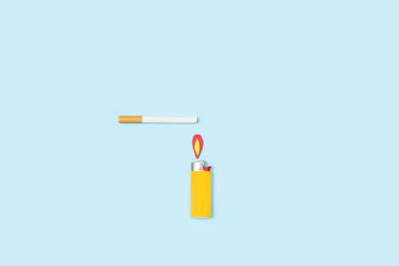 A filter cigarette and a yellow lighter on a light blue background with copy spaceの写真素材