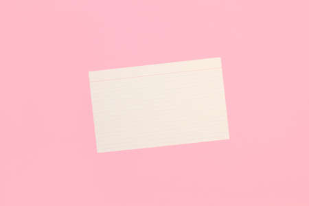 A blank striped paper note on a pink background with copy spaceの写真素材