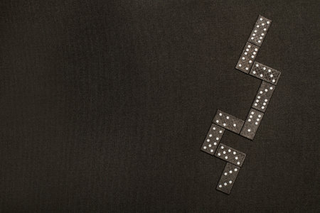 Domino pieces on a black background in a top viewの写真素材