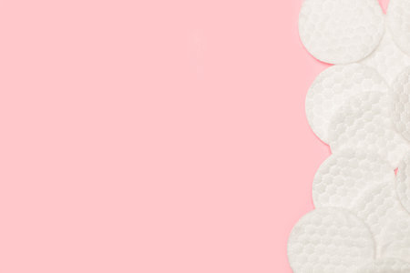 Round cotton pads on a pink background with copy spaceの写真素材