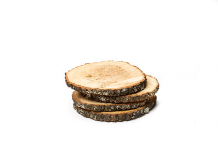A pile of tree trunk slices on a white background with copy space in a top viewの写真素材