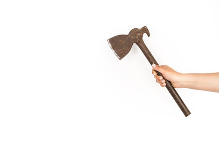 Woman hand holding a rusty ax on a white background with copy spaceの写真素材