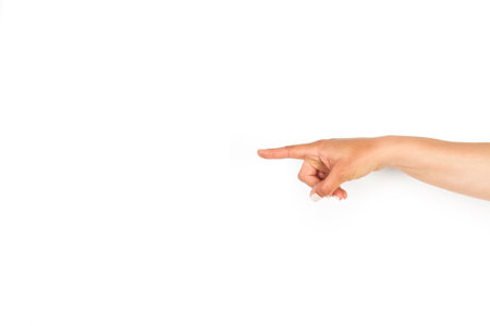 Woman hand with pointing finger on a white background with copy spaceの写真素材