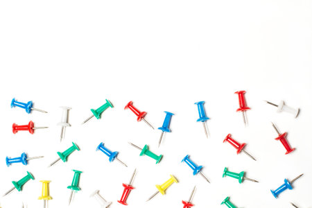 Colored pushpins on a white background with copy spaceの写真素材
