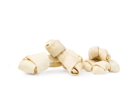Rawhide bones on a white background with copy spaceの写真素材