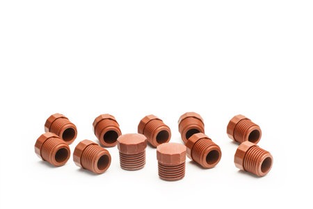 Brown plastic plugs for water pipes on a white background with copy space