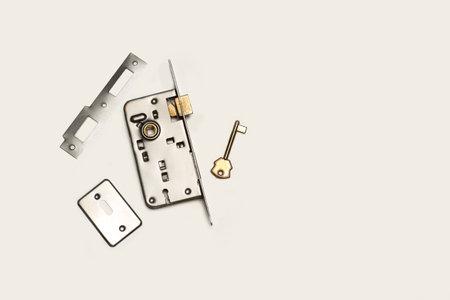 Parts of a door lock on a white background with copy space