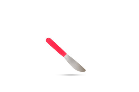 A table knife with red handle floating on a white background with copy spaceの写真素材