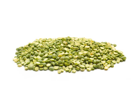 A heap of green lentils on a white background with copy spaceの写真素材