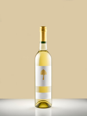 A bottle of white wine on a brown and white backgroundの素材