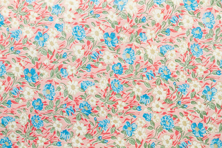 A paper background with white and blue flowers and green leaves