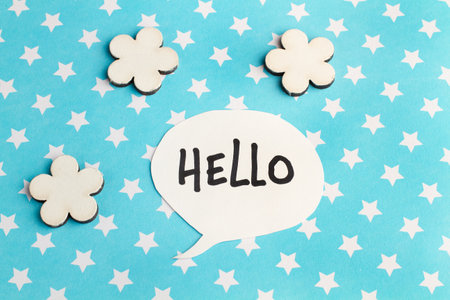 Hello speech bublle on a light blue background with white starsの写真素材
