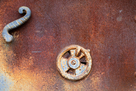 A metal rusty old door of an oven with handles in a close up viewの写真素材