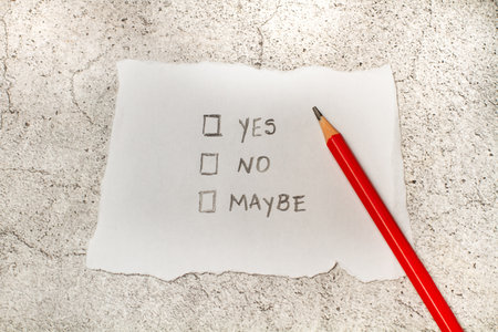 A piece of paper with the words yes, no, and maybe and squares spaces to choose from
