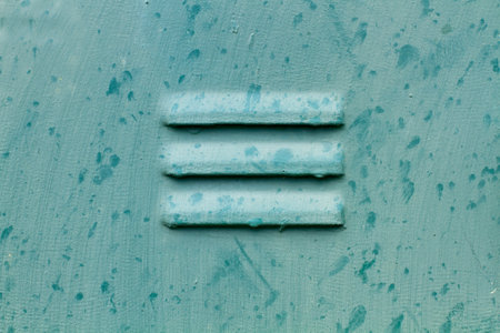 Ventilation of a green metal door in a close up view