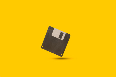 A floppy disk floating on a yellow background