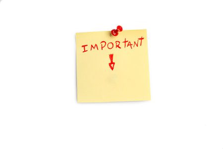 Important single word and a red arrow handwritten on a yellow sticky paper on a white background...