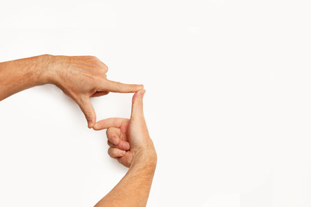 Man hands doing photo framing gesture on a white background with copy space