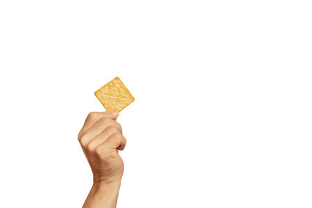 Hand holding a cracker cookie on a white background