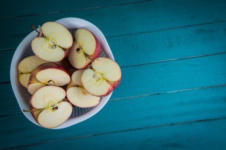 fresh organic apples halves on wooden kitchen table with copy space in backgroundの写真素材