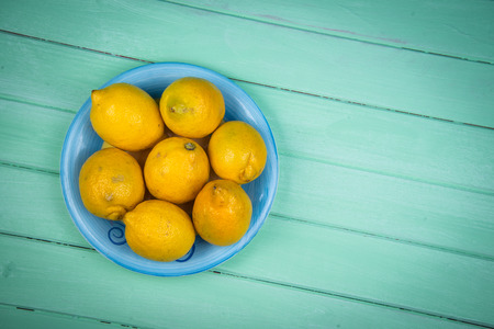 Market fresh organic lemons on wooden table backgroundの写真素材