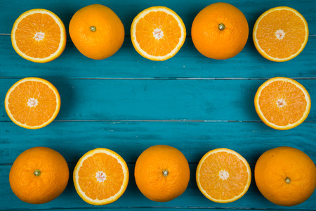 Fresh organic oranges fruits on blue wooden background with copy spaceの写真素材