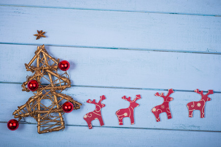 Hand made natural Christmas tree and reindeers on wooden background with copy spaceの写真素材