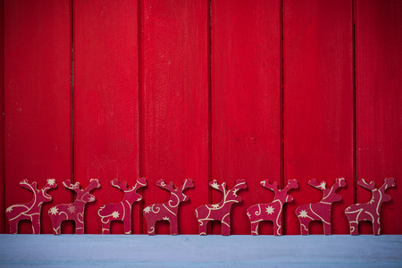 Hand made natural Christmas reindeers on wooden background with copy spaceの写真素材