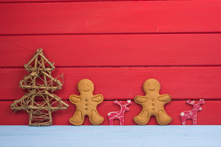 Christmas tree reindeer and gingerbread man on wooden background