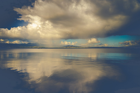 clouds over lake with vintage effectの写真素材