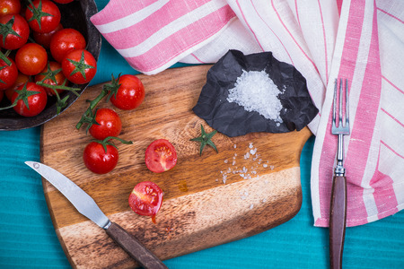 farm fresh ripe tomatoes and salt on tableの写真素材