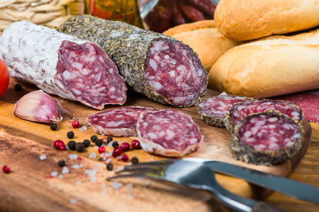 whole and sliced salami with spices and herbs